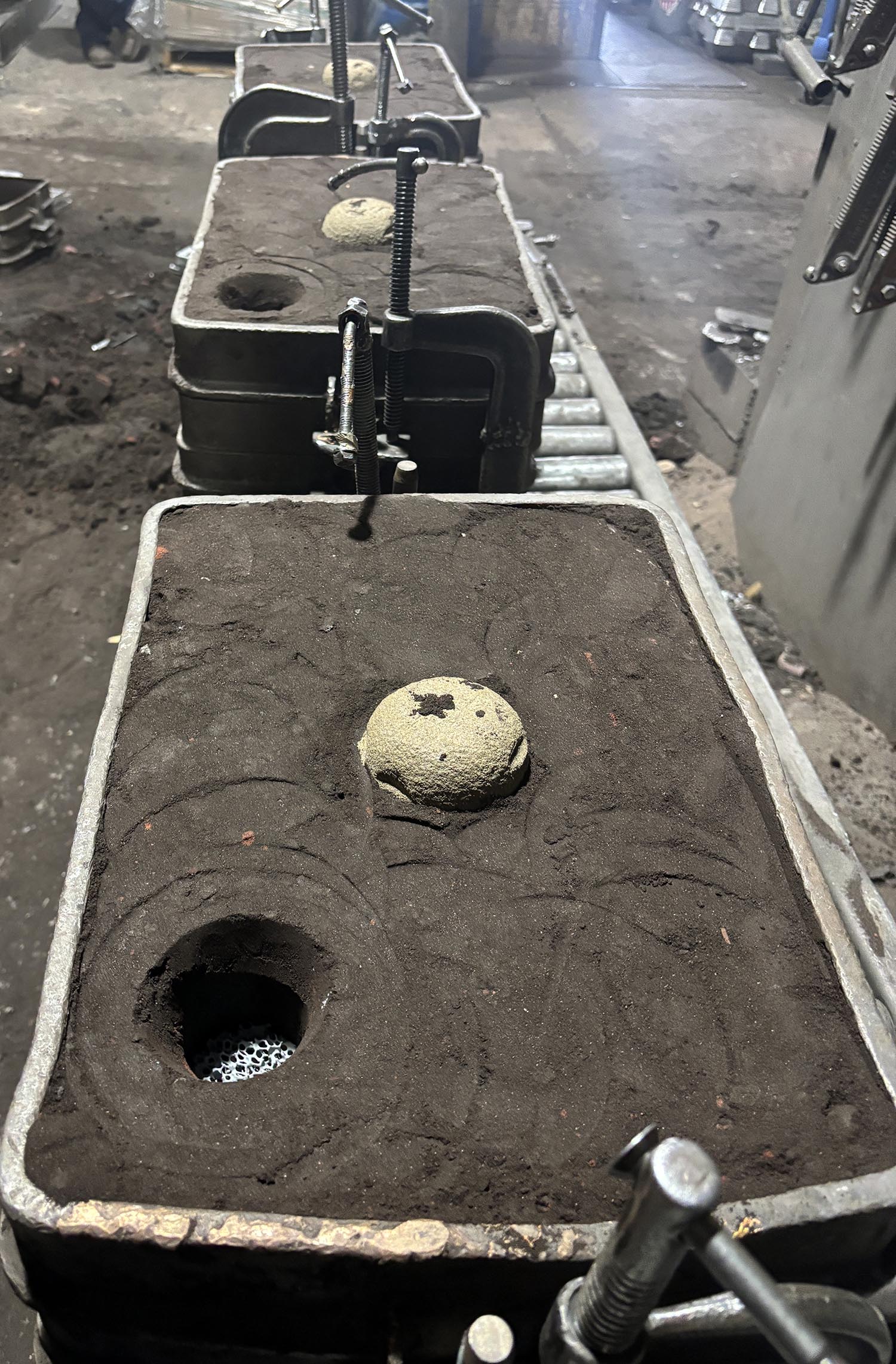 Sand casting mold line with riser sleeve application